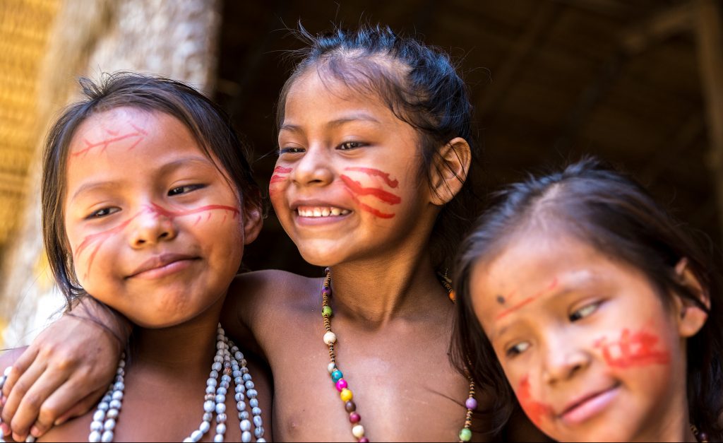 Native American children laughing and playing together. 