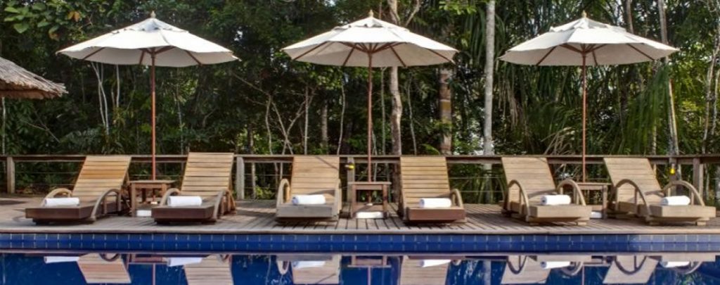Sunbeds at the edge of the poolat Anavilhanas jungle lodge. 