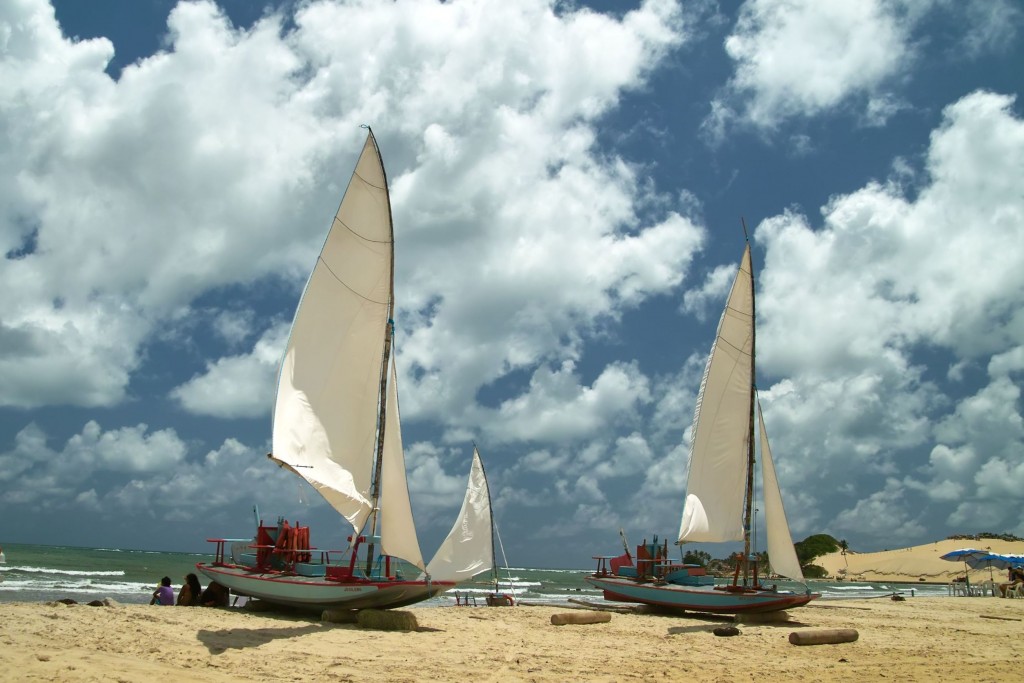 Two jangadas sitting on the beach ready to set sail. 