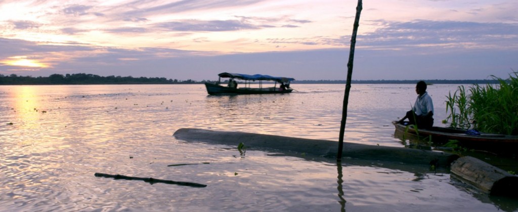 A fisherman comes in off the Amazon river at sunset.