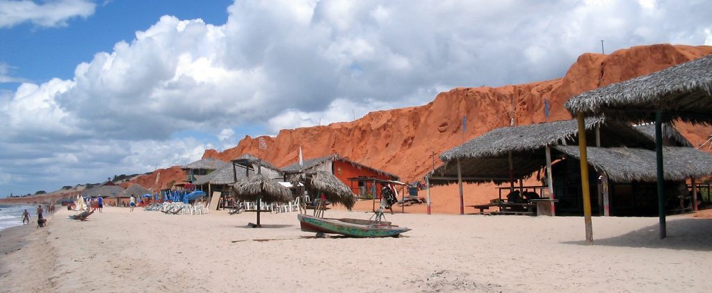 Looking up at the red ocher cliffs at Canoa Quebrada. 