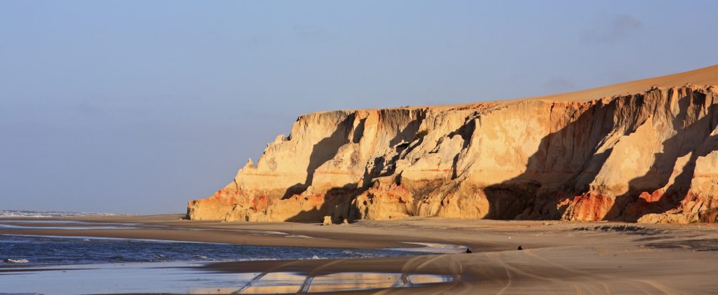 The sun shines on the Ocher cliffs of the Nordeste coast. 