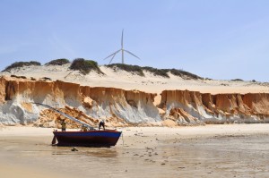 A jangada perched in front of the red ocher cliffs of Canoa Quebrada.