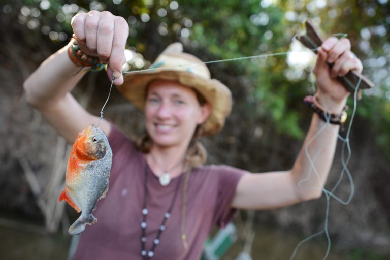 A tourist shows off her catch in the Amazon. 