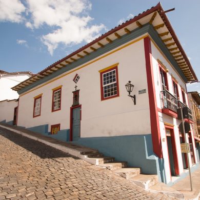 A colourful house sits on a street corner in Ouro Preto.