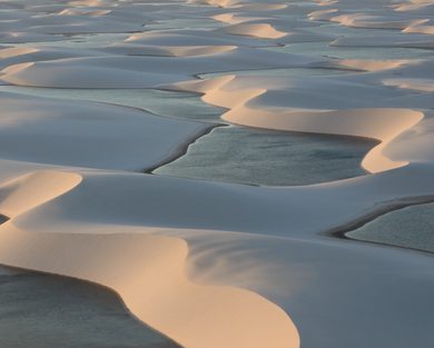 The sunset bounces off the rainwater lagoons in the Lençóis Maranhenses.