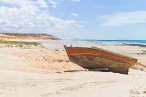 A jangada sitting far up the beach. 