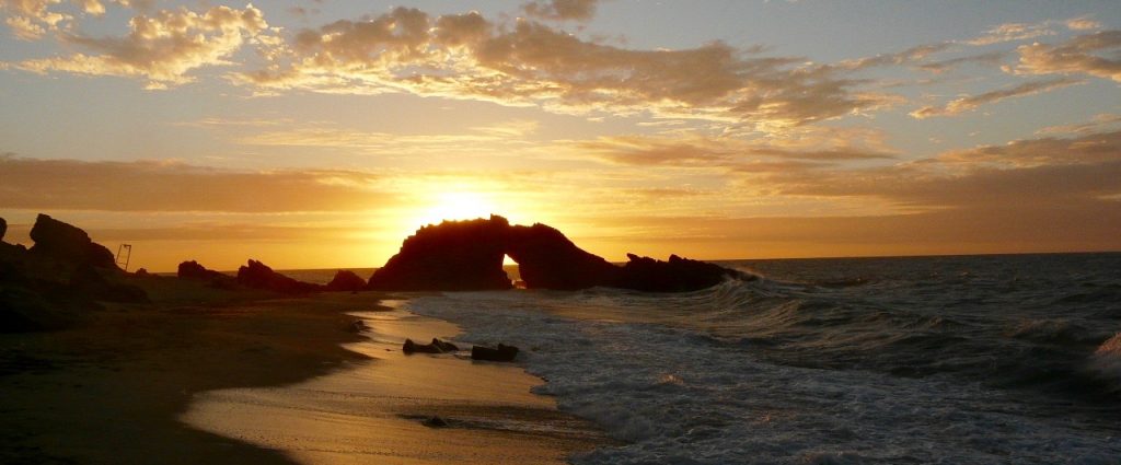 Sunset at the pierced rock in Jericoacoara. 