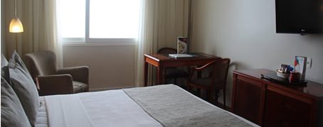 Room at the hotel Olinda in Rio de Janeiro with the sun shining in through the window. 