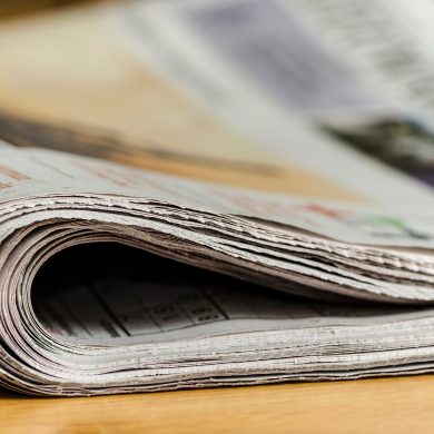 Close up shot of folded over newspaper.