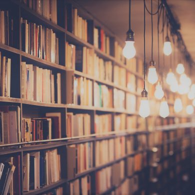 A library lit by dangling lightbulbs.