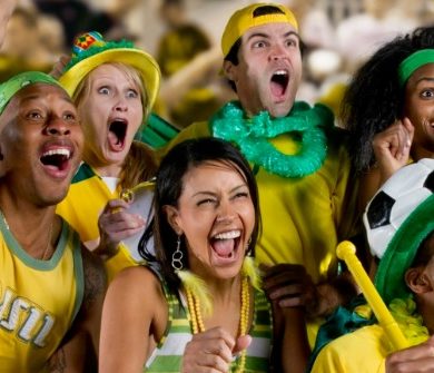 A group of Brazilian football supporters cheer on their team.