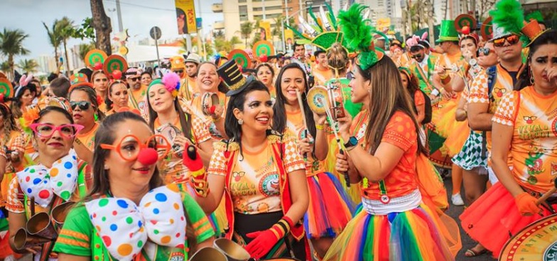 A crowd dressed in orange parades at pre-carnaval in Fortaleza.