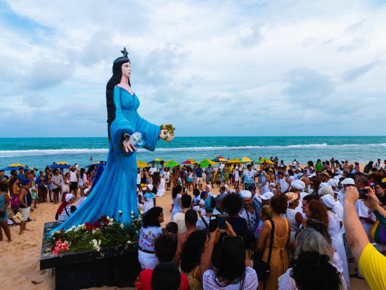 People gathered in front of a Iemanja statue